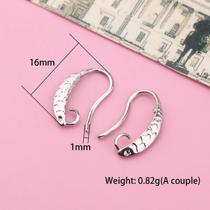 Macro detail of silver-plated fish scale texture DIY earring hooks for jewelry making