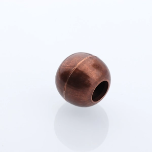 Detailed view of an antique bronze DIY jewelry bead with a central hole for cord threading