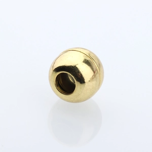 Macro view of gold spherical magnetic clasp for DIY jewelry leather cord connection