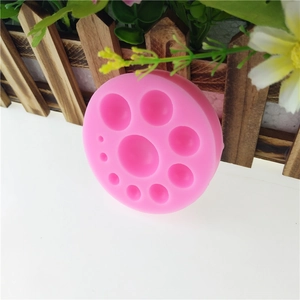 Pink silicone mold with circular bead cavities for DIY fondant and chocolate cake decorating