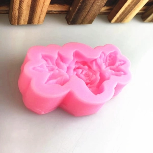 Pink silicone mold with three mini rose designs for DIY fondant and cake decoration