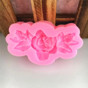 Pink silicone DIY mold featuring a detailed 3D rose flower and leaf patterns for fondant cake