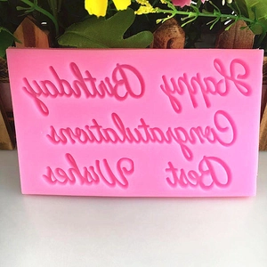 Pink silicone mold featuring Happy Birthday, Best Wishes, and Congratulations patterns