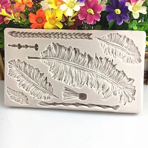 Silicone feather leaf mold for fondant and chocolate cake decorating on floral background
