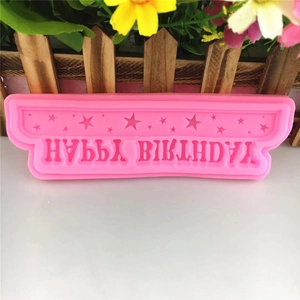Pink silicone mold with Happy Birthday text and star patterns for cake decorating