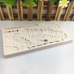 Grey silicone mold with various feather leaf textures for fondant and DIY crafts
