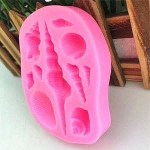 Pink silicone mold featuring various sea shells and starfish shapes for DIY fondant cake decor