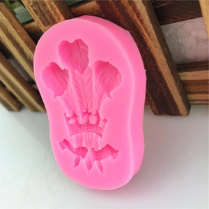 Pink silicone mold featuring triple feather crown design for DIY cake decorating