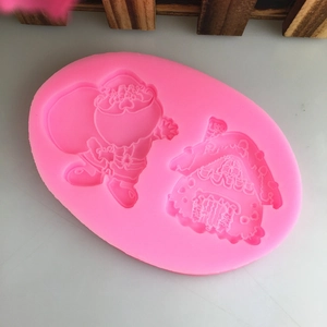 Pink silicone mold featuring 3D Santa and Christmas gingerbread house for DIY fondant