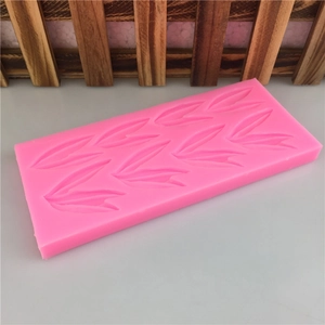 Pink rectangular silicone mold with leaf patterns for DIY cake and chocolate baking