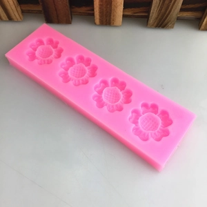 Pink silicone mold with 4 floral shapes for cake decorating and DIY crafts