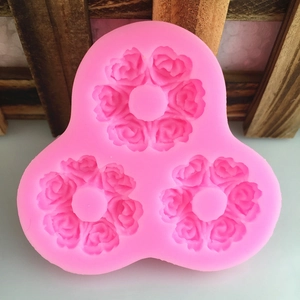 Pink silicone mold with three rose floral shapes for DIY fondant cake decorating and baking