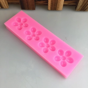 Pink silicone mold featuring four 5-petal flower cavities for cake fondant and DIY baking
