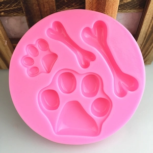 Pink silicone mold with pet paw prints and bone shapes for DIY baking and crafts