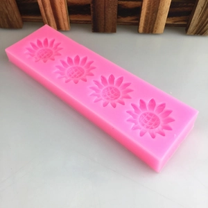 Pink silicone mold featuring four detailed sunflower shapes for cake fondant and DIY crafts
