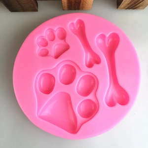 Pink silicone mold with dog paw and bone shapes for DIY chocolate and cake baking