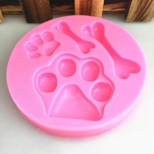 Pink silicone mold featuring dog paw and bone shapes for DIY chocolate and cake decoration