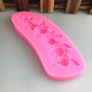 Pink silicone mold featuring intricate 5-flower vine and leaf patterns for fondant cakes