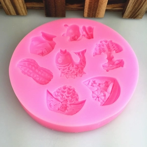 Pink silicone mold featuring fish and flower patterns for fondant or chocolate