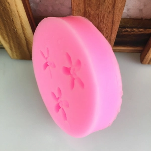 Pink silicone mold featuring three orchid flower patterns for DIY fondant and chocolate
