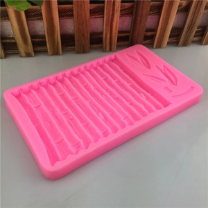 Pink silicone mold featuring detailed bamboo leaf patterns for cake fondant and chocolate