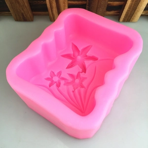 Pink silicone mold featuring three intricate daffodil floral patterns for soap making
