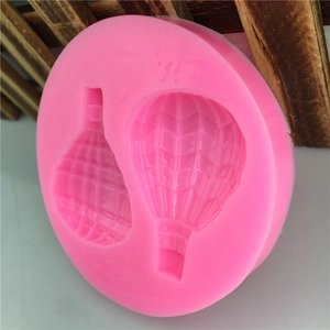 Pink silicone mold featuring dual hot air balloon shapes for DIY fondant and cake decorating
