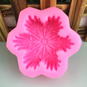 Pink silicone snowflake mold for DIY soap candles and cake baking with intricate patterns
