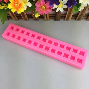 Pink flexible silicone mold with 22 rectangular slots for 3D alphabet chocolate making