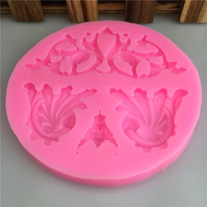 Pink silicone mold featuring European scroll and floral relief patterns for cake decoration