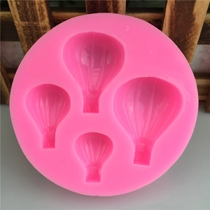 Pink silicone mold featuring four various sized hot air balloon shapes for DIY cake decorating