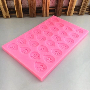 Pink silicone mold featuring 26 uppercase balloon-shaped alphabet letters for baking decor