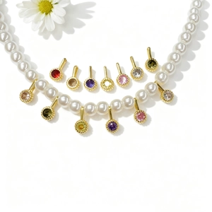 White pearl necklace set with colorful zircon round pendants in a golden finish