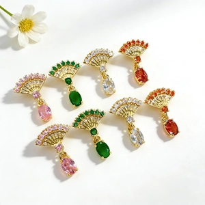 Macro view of fan-shaped pendant jewelry featuring sparkling zircon and colorful stones