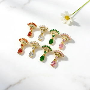 Close-up of fan-shaped pendants with gold plating and colorful zircon stone inlay