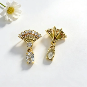 Elegant gold fan-shaped drop earrings with sparkling crystals and large oval stones