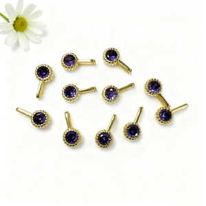 Detail showing ten round purple zircon pendants with gold plated edges for DIY jewelry