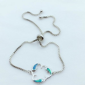 Adjustable silver dolphin bracelet featuring blue opal inlay and a secure box chain slider