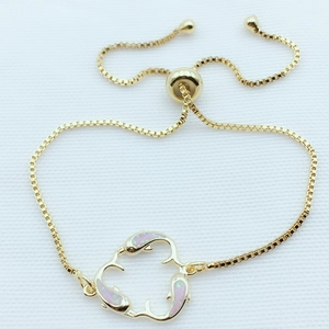 Detail of adjustable golden slider clasp and box chain on dolphin charm bracelet