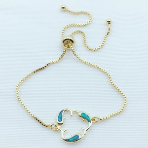 Detailed macro view of the adjustable dolphin bracelet with turquoise opal stone inlays