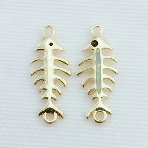 Detalle macro de colgantes de espina de pescado chapados en oro con ópalo para joyas