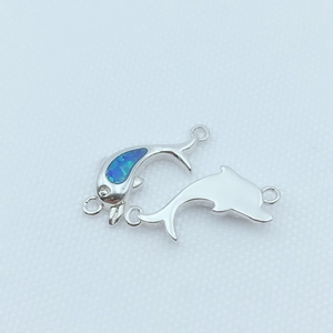 Detailed view of silver dolphin connector with blue opal inlay for DIY jewelry making