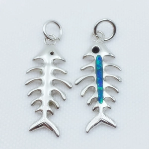 Detail of silver fishbone pendants with turquoise opal inlay for DIY jewelry making