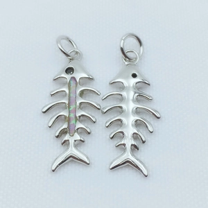 Macro detail of silver fishbone pendants featuring colorful synthetic opal inlay detail