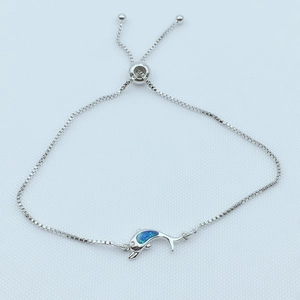 Macro shot of dolphin connector with blue opal inlay and silver-tone sliding ball clasp