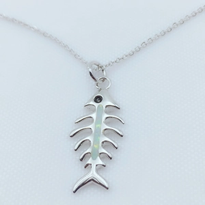 Detailed view of a gold-plated fishbone pendant featuring iridescent opal inlay details