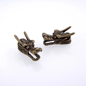 Macro detail of vintage alloy dragon head pendants for DIY jewelry making