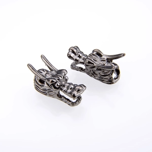 Detailed close-up of retro silver dragon head metal beads for DIY jewelry making