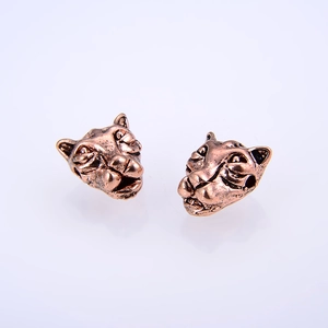 Macro detail of two vintage bronze leopard head beads for DIY jewelry and bracelet making