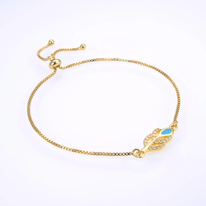 Detail of adjustable gold leaf bracelet with blue opal and cubic zirconia inlay
